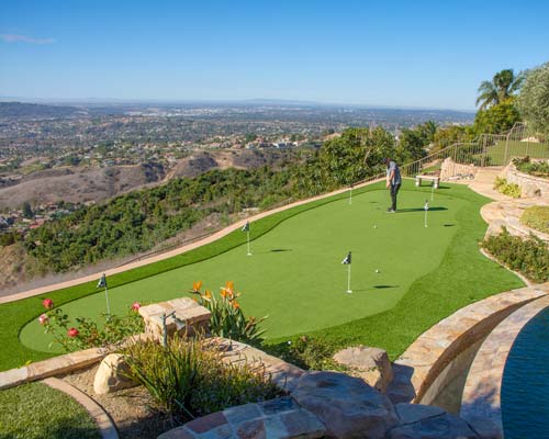 Backyard artificial putting green installation in Yorba Linda hillside home