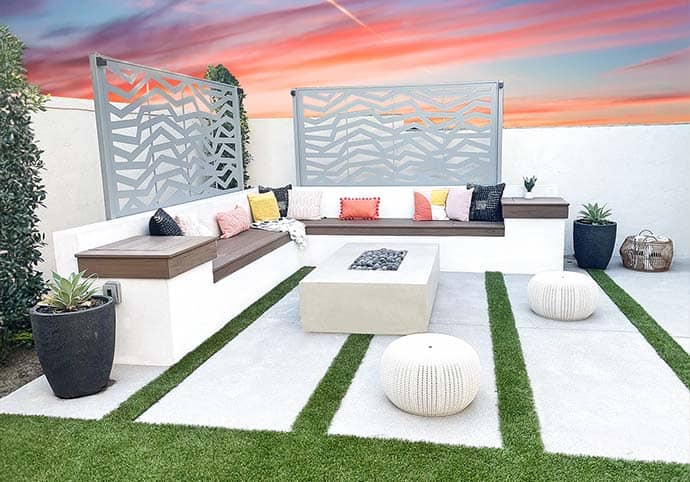 WEBSITE-HOME-PAGE-THUMBNAILS-OLS-No-Text Custom outdoor living space with built-in seating, fire pit, and decorative privacy panels