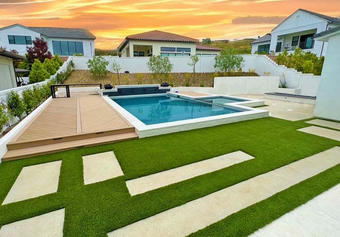 WEBSITE-HOME-PAGE-THUMBNAILS-OLS2-No-Text Modern backyard design with custom swimming pool, artificial turf lawn, and concrete stepping stone paths